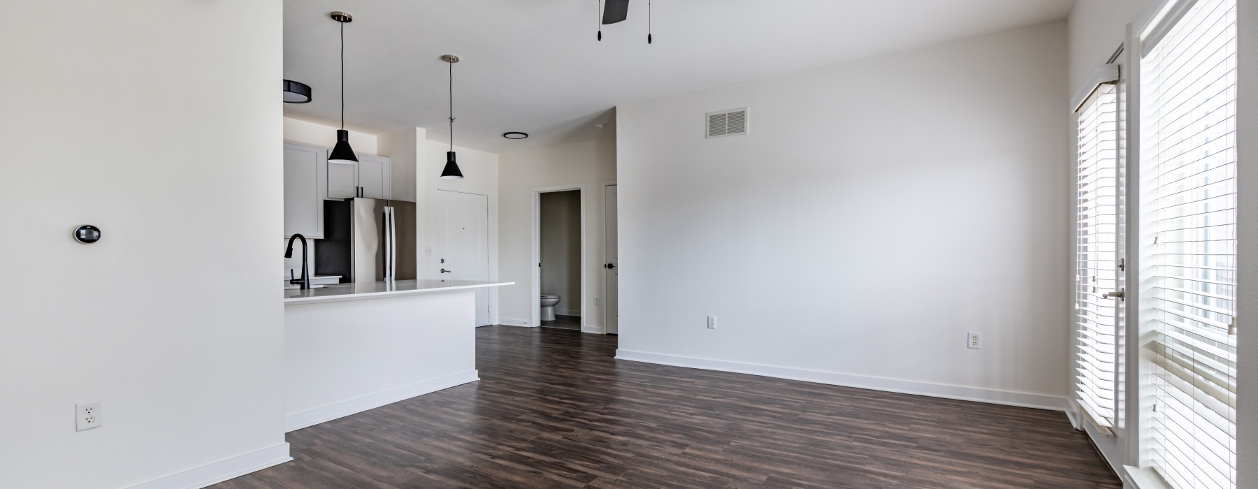 Open concept living room with large windows