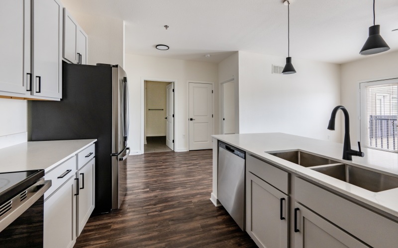 Kitchen with gray cabinets and stainless steel appliances