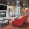 a lounge with a couch chairs and a tv